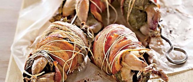 Перепела на вертеле в беконе и виноградных листьях